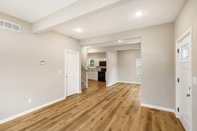 1101 Pannell St, Columbia, MO 65201 - unfurnished living room with light wood-style flooring, stairway, recessed lighting, and healthy amount of natural light