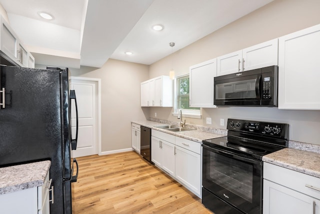 1101 Pannell St, Columbia, MO 65201 - kitchen featuring black appliances, light wood-type flooring, white cabinetry, light countertops, and recessed lighting