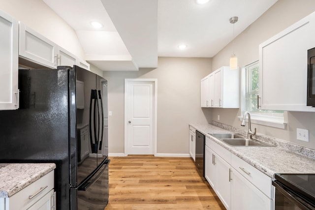 1101 Pannell St, Columbia, MO 65201 - kitchen with freestanding refrigerator, light wood finished floors, dishwasher, light countertops, and white cabinets
