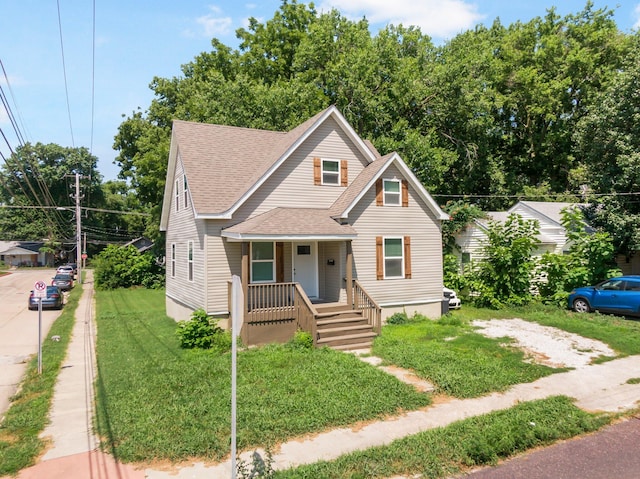 1101 Pannell St, Columbia, MO 65201 - bungalow-style house featuring a porch, roof with shingles, and a front lawn
