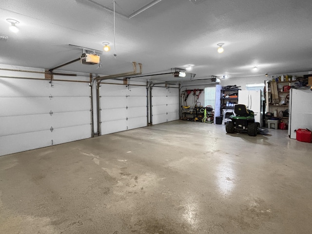307 Jameson Dr, Ashland, MO 65010 - garage featuring a garage door opener and freestanding refrigerator