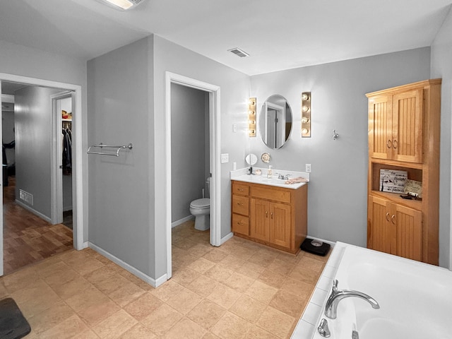 307 Jameson Dr, Ashland, MO 65010 - bathroom featuring vanity, a bath, and a walk in closet