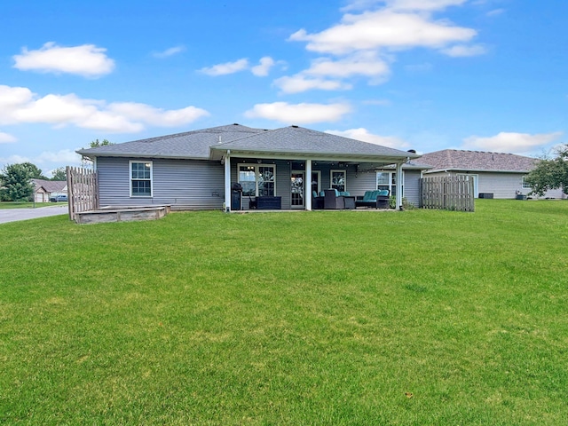 307 Jameson Dr, Ashland, MO 65010 - back of house with a yard, an outdoor living space, a patio area, and roof with shingles