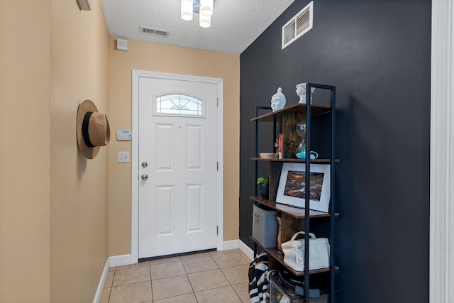 547 E Clearview Dr, Columbia, MO 65202 - foyer featuring a textured ceiling and light tile patterned floors