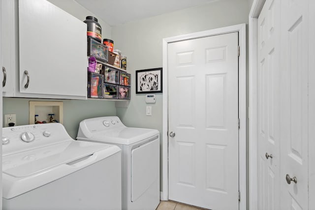 547 E Clearview Dr, Columbia, MO 65202 - washroom featuring washing machine and dryer, cabinet space, and light tile patterned flooring
