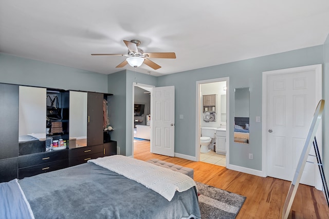 547 E Clearview Dr, Columbia, MO 65202 - bedroom with light wood finished floors, ensuite bathroom, and a ceiling fan