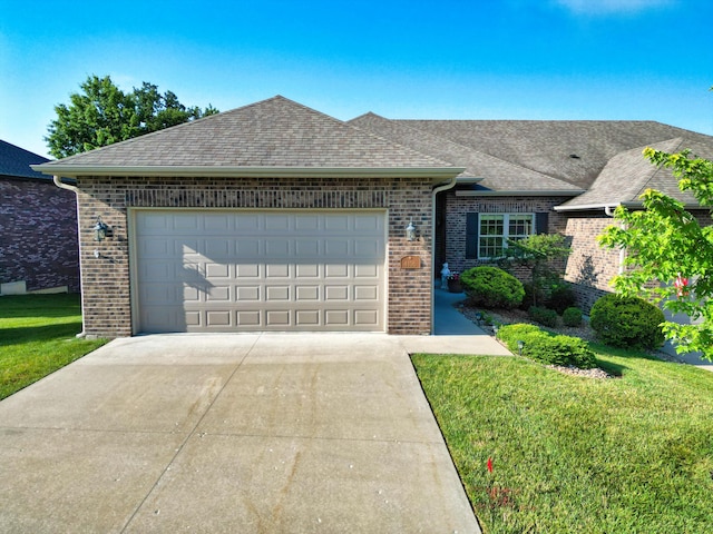 4106 Fritz Ct, Columbia, MO 65203 - view of front facade featuring brick siding, a garage, concrete driveway, a front lawn, and a shingled roof