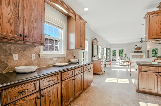 4106 Fritz Ct, Columbia, MO 65203 - kitchen with dark countertops, healthy amount of natural light, tasteful backsplash, ornamental molding, and recessed lighting