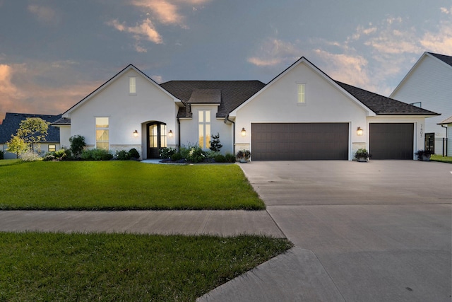 7405 Brackenhill Dr, Columbia, MO 65203 - view of front facade with an attached garage, a front yard, concrete driveway, and stucco siding