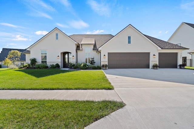 7405 Brackenhill Dr, Columbia, MO 65203 - view of front of property featuring stucco siding, a front yard, an attached garage, and driveway