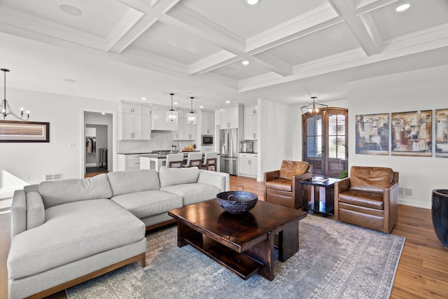7405 Brackenhill Dr, Columbia, MO 65203 - living room featuring a chandelier, light wood-style flooring, coffered ceiling, and beam ceiling