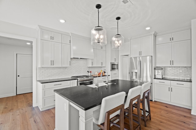 7405 Brackenhill Dr, Columbia, MO 65203 - kitchen with appliances with stainless steel finishes, custom range hood, dark countertops, tasteful backsplash, and recessed lighting
