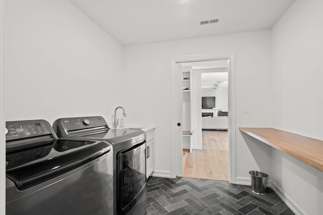 7405 Brackenhill Dr, Columbia, MO 65203 - laundry room with independent washer and dryer and cabinet space