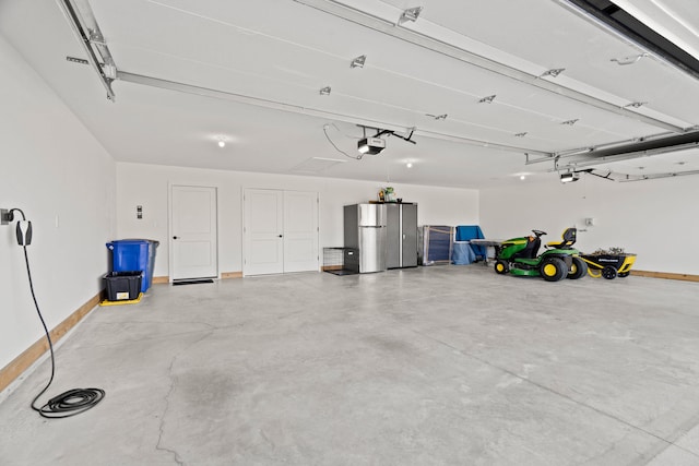 7405 Brackenhill Dr, Columbia, MO 65203 - garage featuring a garage door opener and freestanding refrigerator
