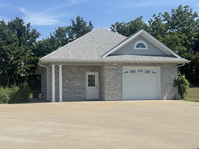 3824 Canyon Ridge Dr, Columbia, MO 65202 - view of front of property with driveway, an attached garage, brick siding, and roof with shingles