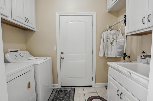 3824 Canyon Ridge Dr, Columbia, MO 65202 - washroom featuring independent washer and dryer, cabinet space, and light tile patterned flooring