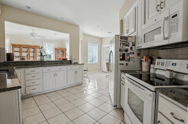 3824 Canyon Ridge Dr, Columbia, MO 65202 - kitchen with white appliances, tasteful backsplash, light tile patterned flooring, ceiling fan, and white cabinetry