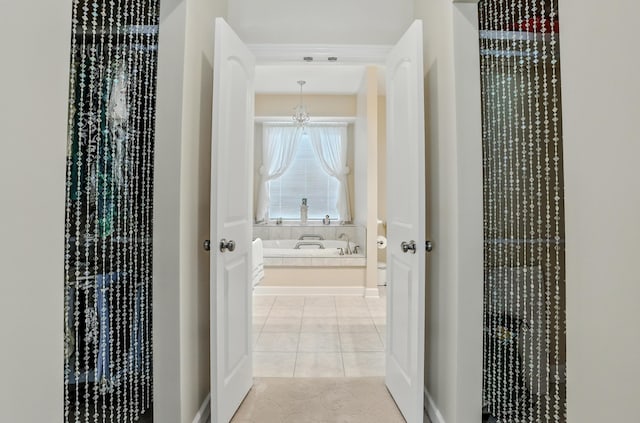 3824 Canyon Ridge Dr, Columbia, MO 65202 - corridor with light tile patterned floors and a chandelier