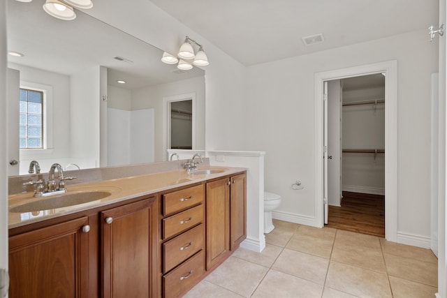 3106 Crabapple Ln, Columbia, MO 65203 - full bathroom with double vanity, a walk in closet, and tile patterned floors
