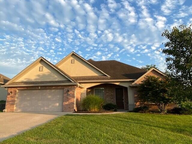 3106 Crabapple Ln, Columbia, MO 65203 - single story home featuring an attached garage, concrete driveway, a front lawn, and stucco siding