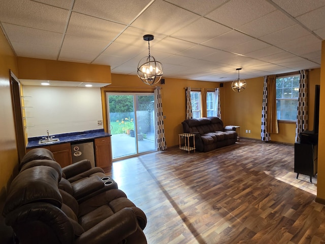 7951 N Marigold Ct, Columbia, MO 65202 - living room featuring a chandelier, dark wood-type flooring, healthy amount of natural light, and a paneled ceiling