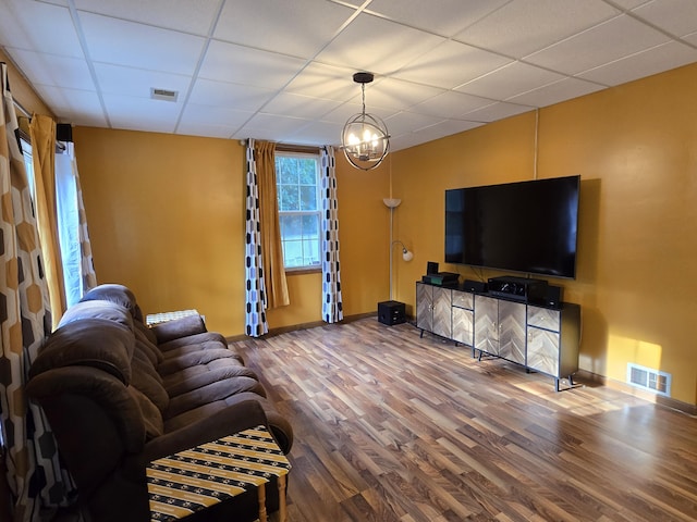 7951 N Marigold Ct, Columbia, MO 65202 - living room with wood finished floors, a paneled ceiling, and a chandelier