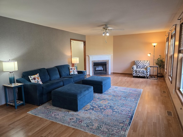 7951 N Marigold Ct, Columbia, MO 65202 - living area with a ceiling fan, wood finished floors, and a fireplace