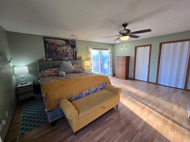 7951 N Marigold Ct, Columbia, MO 65202 - bedroom with wood finished floors and ceiling fan