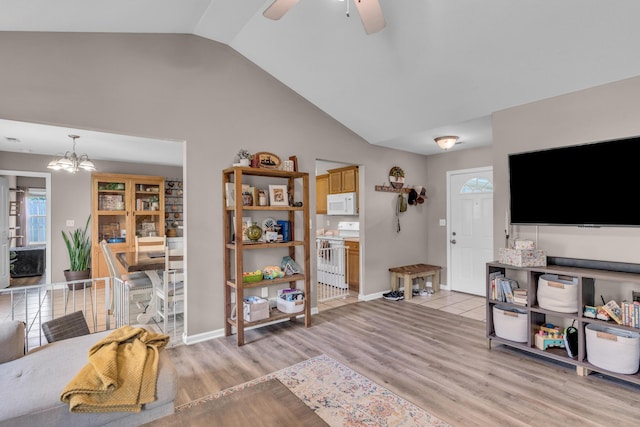 3810 Crocodile Dr, Columbia, MO 65202 - living room featuring light wood-style floors, a chandelier, a ceiling fan, and high vaulted ceiling
