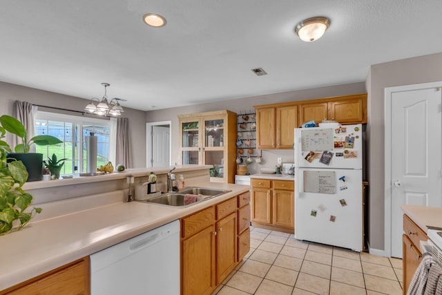 3810 Crocodile Dr, Columbia, MO 65202 - kitchen with white appliances, light tile patterned floors, light countertops, a chandelier, and decorative light fixtures