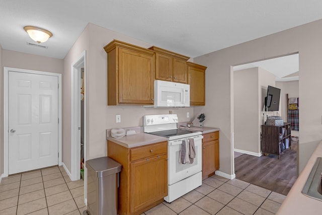 3810 Crocodile Dr, Columbia, MO 65202 - kitchen with white appliances, light tile patterned flooring, and light countertops
