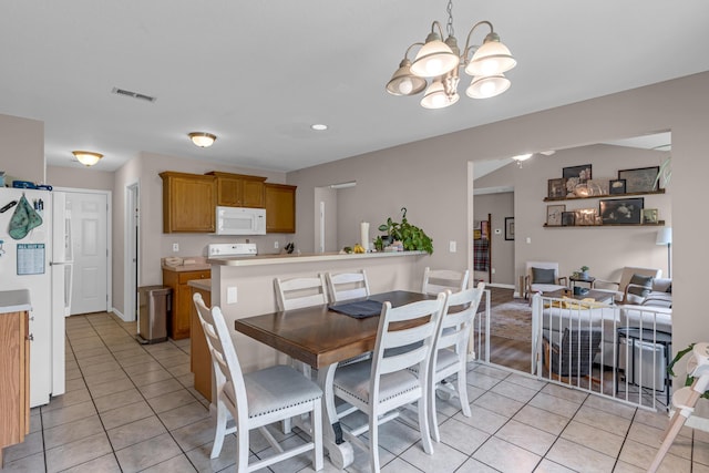 3810 Crocodile Dr, Columbia, MO 65202 - dining space featuring light tile patterned floors and a chandelier