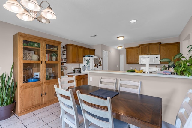 3810 Crocodile Dr, Columbia, MO 65202 - dining room featuring a chandelier and light tile patterned floors