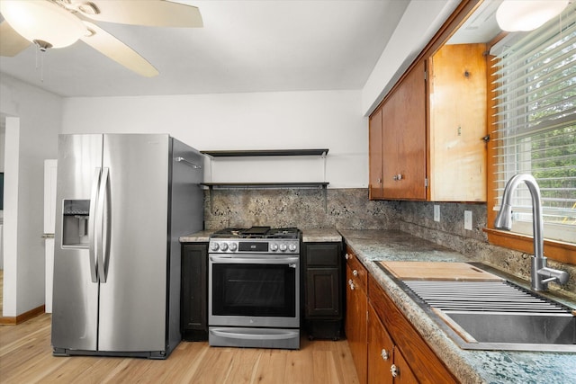 201 Ruby Ln, Columbia, MO 65203 - kitchen featuring appliances with stainless steel finishes, light wood-style flooring, tasteful backsplash, and a ceiling fan