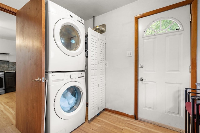 201 Ruby Ln, Columbia, MO 65203 - washroom with stacked washer / dryer and light wood-type flooring