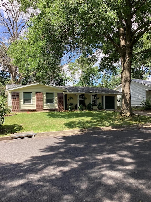 113 E El Cortez Dr, Columbia, MO 65203 - ranch-style house featuring an attached garage, a front yard, and brick siding