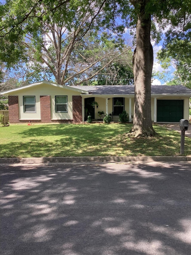 113 E El Cortez Dr, Columbia, MO 65203 - ranch-style house featuring brick siding, an attached garage, a front lawn, and driveway