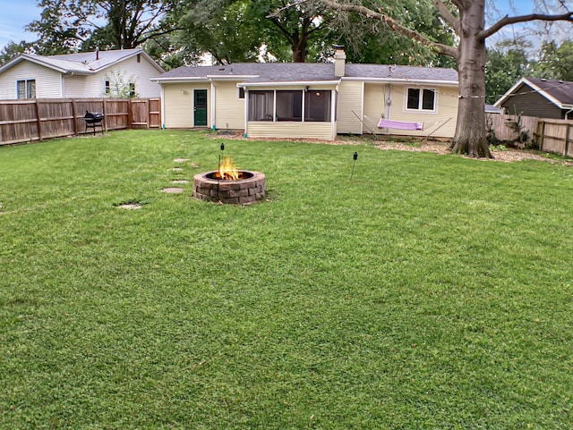 113 E El Cortez Dr, Columbia, MO 65203 - back of property with a fire pit, a sunroom, a fenced backyard, and a chimney