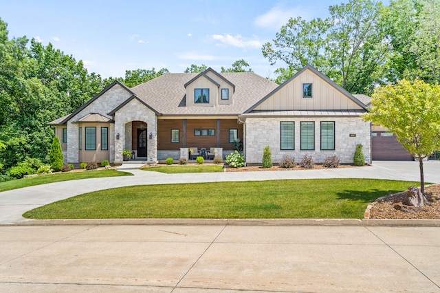 1880 W Cresskill Dr, Columbia, MO 65203 - view of front of house with stone siding, curved driveway, a front yard, and a shingled roof