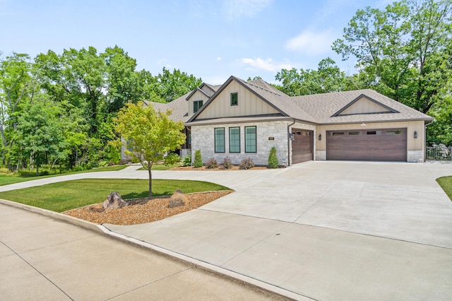 1880 W Cresskill Dr, Columbia, MO 65203 - view of front of property with concrete driveway, board and batten siding, stone siding, an attached garage, and roof with shingles