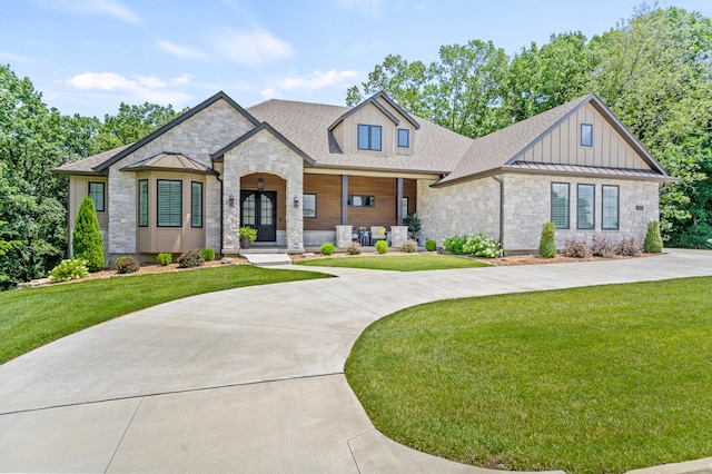1880 W Cresskill Dr, Columbia, MO 65203 - view of front of property featuring stone siding, a standing seam roof, and a front lawn