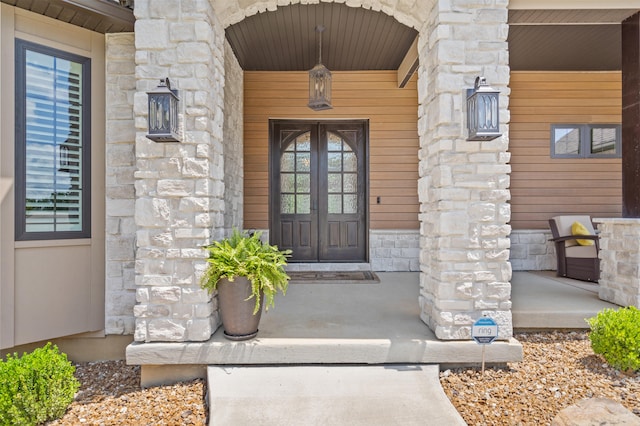 1880 W Cresskill Dr, Columbia, MO 65203 - property entrance featuring stone siding, covered porch, and french doors