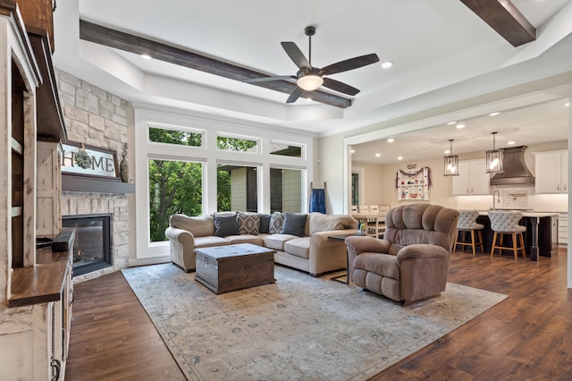 1880 W Cresskill Dr, Columbia, MO 65203 - living area featuring ceiling fan, dark wood-style floors, recessed lighting, a stone fireplace, and beam ceiling