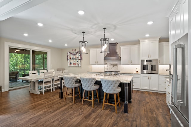 1880 W Cresskill Dr, Columbia, MO 65203 - kitchen with oven, wall chimney range hood, high end fridge, backsplash, and white cabinets