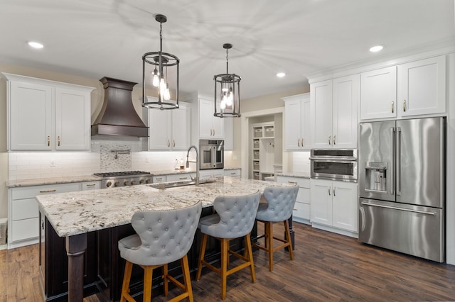 1880 W Cresskill Dr, Columbia, MO 65203 - kitchen with appliances with stainless steel finishes, custom exhaust hood, recessed lighting, a kitchen island with sink, and decorative backsplash