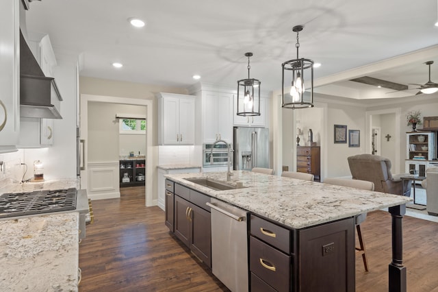 1880 W Cresskill Dr, Columbia, MO 65203 - kitchen with appliances with stainless steel finishes, wall chimney exhaust hood, white cabinetry, open floor plan, and dark brown cabinets