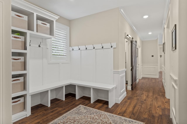 1880 W Cresskill Dr, Columbia, MO 65203 - mudroom with a barn door, a decorative wall, dark wood-type flooring, a wainscoted wall, and ornamental molding