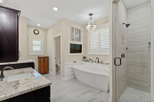1880 W Cresskill Dr, Columbia, MO 65203 - bathroom with a shower stall, a freestanding tub, vanity, marble finish floors, and a chandelier