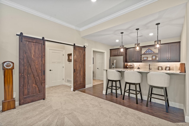 1880 W Cresskill Dr, Columbia, MO 65203 - kitchen featuring stainless steel fridge, a kitchen bar, a barn door, carpet, and crown molding