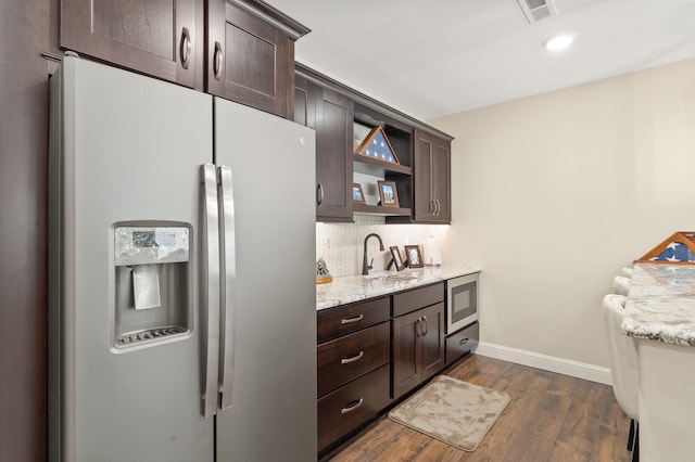 1880 W Cresskill Dr, Columbia, MO 65203 - kitchen featuring refrigerator with ice dispenser, dark brown cabinetry, stainless steel microwave, and recessed lighting